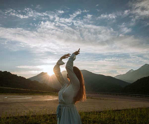 Silhouette of a woman meditating with a peaceful expression.